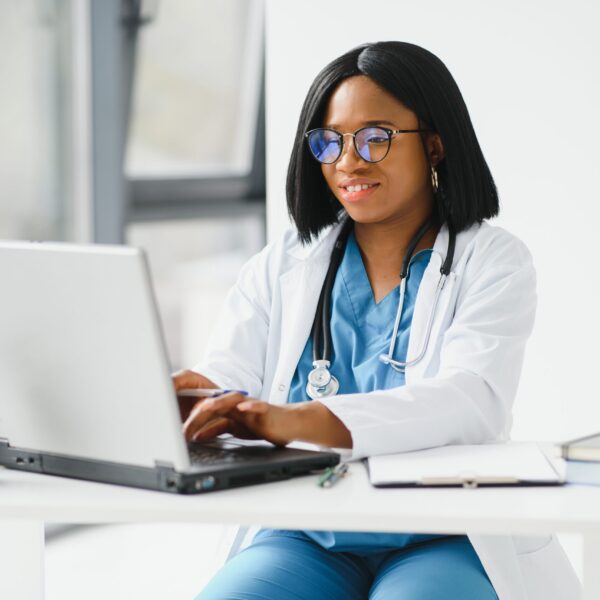 African American doctor working in her office at clinic